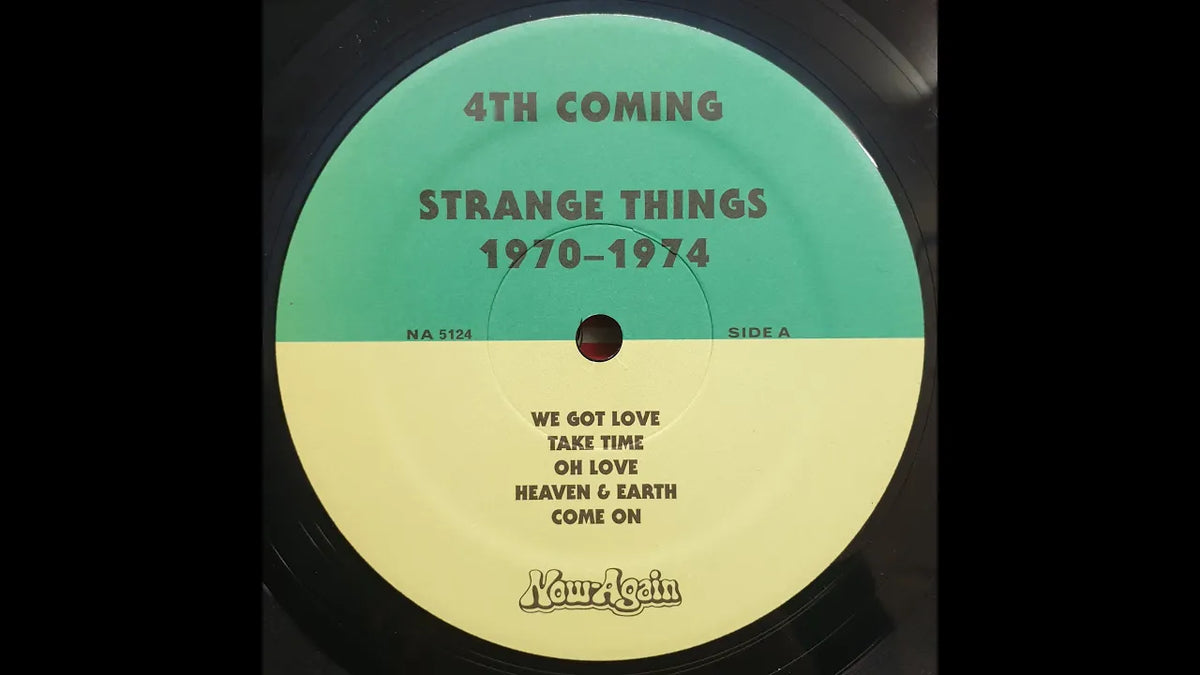 Load video: 4th Coming - Strange Things (1970-1974), compilation, on the turntable. The track is, Take Time. The vinyl is black with a yellow and green label. The turn table is a Technics Sl1200 MK3 with a green metal cover.