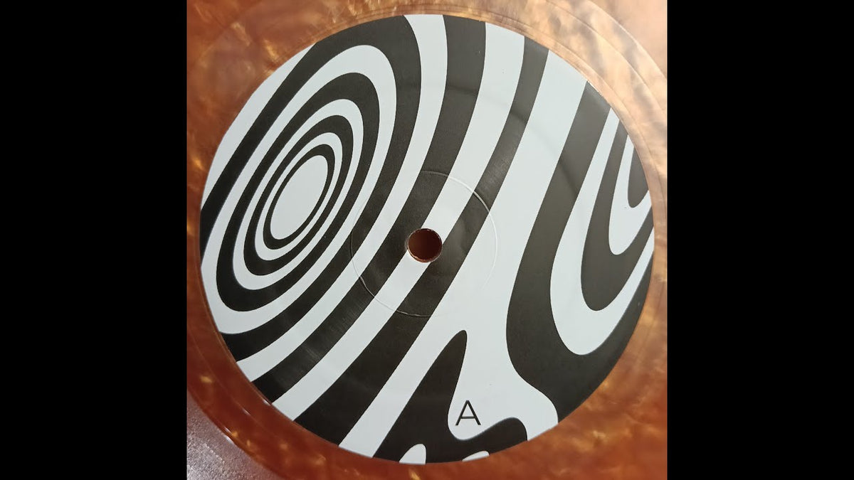 Load video: Wooden Shjips - Back To Land on the turn table, The vinyl is a copper colour (Hi-Copper Melt), the label has psychedelic black and white swirls. The turn table is a Technics SL1200 MK3 with a green metal cover. The song is, These Shadows.